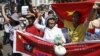 Protesters hold banners while chanting slogans during an anti-China protest along a street in Hanoi, July 22, 2012.