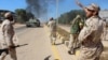Soldiers from a force aligned with Libya's new unity government walk along a road during an advance on the eastern and southern outskirts of the Islamic State stronghold of Sirte, in this still image taken from video on June 9, 2016. 
