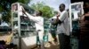 FILE - A mobile phone vendor from Cameroon prepares for a day of business in Juba, southern Sudan.