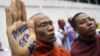  A Buddhist monk shows a message written in his palm to protest against the ethnic minority Rohingyas in Burma during a visit of Burma's President Thein Sein in Bangkok, Thailand, July 24, 2012.