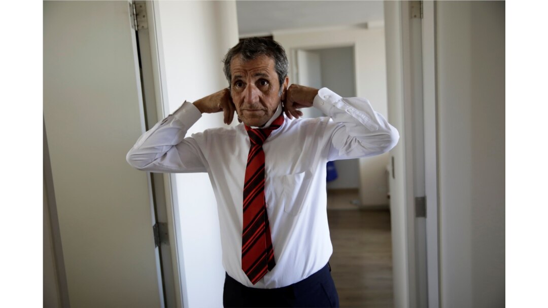 Gino Rojas gets dressed at his house in Santiago, Chile, Dec. 9, 2019.