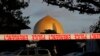 A police officer stands guard in front of the Al Noor Mosque in Christchurch, New Zealand, March 17, 2019, where one of the two mass shootings occurred. New Zealanders reached out to Muslims around the country Saturday, determined to show kindness to a community in pain.