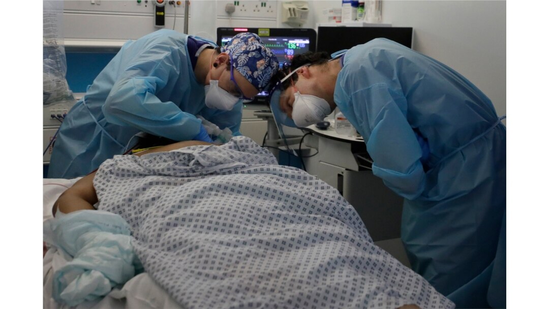 FILE - Critical care staff look after a COVID-19 patient on the Christine Brown ward at King's College Hospital in London, Jan. 27, 2021.