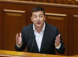 FILE - Ukrainian President Volodymyr Zelenskiy speaks to newly elected Ukrainian parliament deputies during parliament session in Kyiv, Aug. 29, 2019.