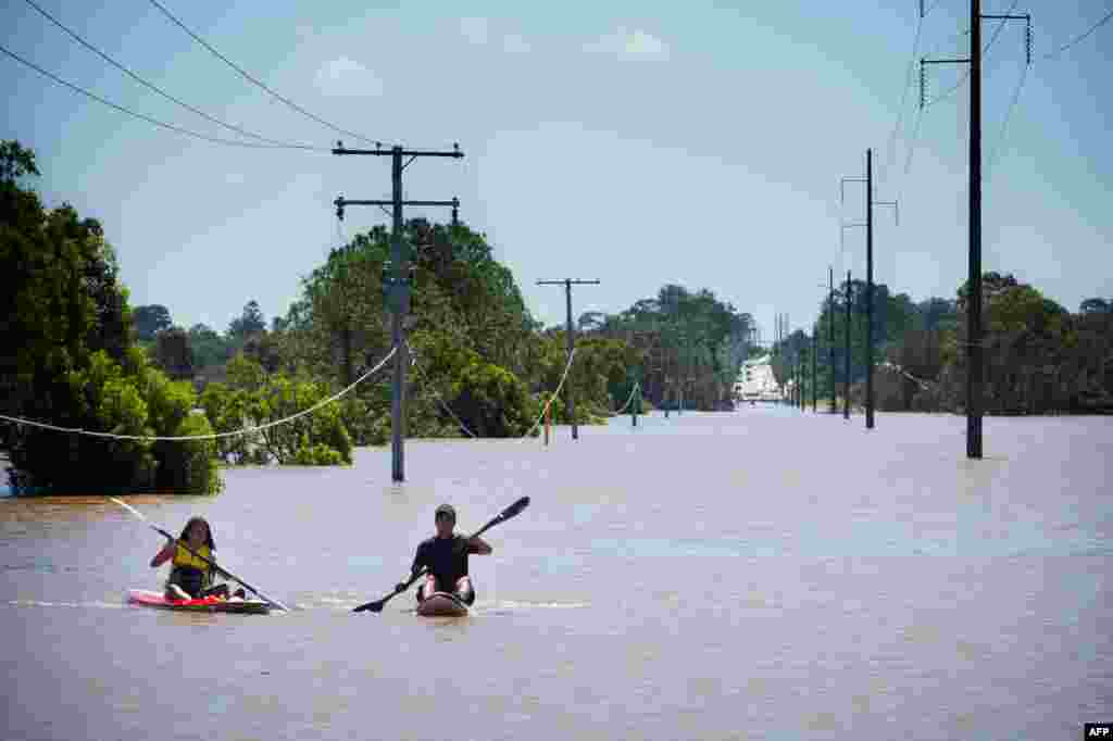 Kayakers paddle on the flooded Logan River, caused by Cyclone Debbie, as it flows over the Mt. Lindesay Highway in Waterford West near Brisbane, Australia, April 1, 2017.