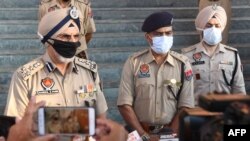 Punjab Police Hardial Singh Mann (L) speaks to media at Tarn Taran, some 25 km from Amritsar, India, Aug. 1, 2020. At least 40 people have died in three Punjab's districts after reportedly drinking spurious liquor over two days, local media reported.