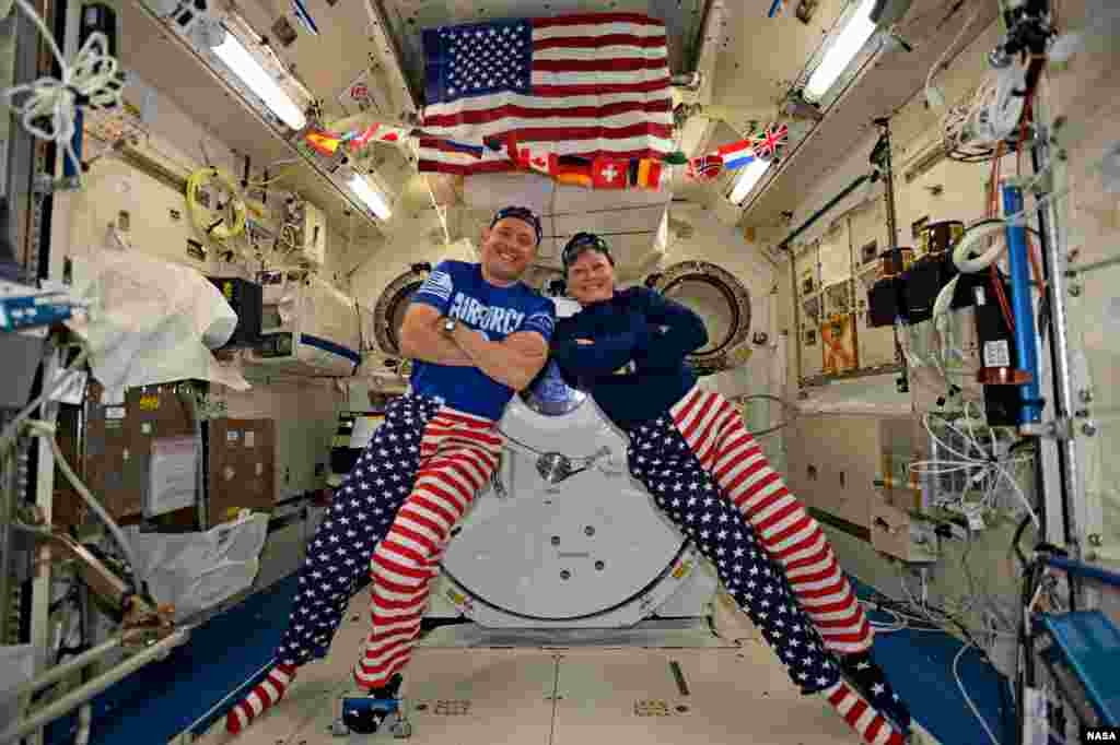 NASA astronauts Jack Fischer and Peggy Whitson celebrate the Fourth of July from over 250 miles above Earth on the International Space Station. Fischer shared this photo on social media and said, "We sometimes have issues standing up straight, but we have no problems at all showing our American pride-Happy 4th!"
