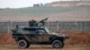FILE - A Turkish military vehicle is seen patrolling the Turkey-Syrian border near the Akcakale border crossing in Turkey, January 2015.
