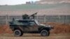 FILE - A Turkish military vehicle is seen patrolling the Turkey-Syrian border near the Akcakale border crossing in Turkey, January 2015.