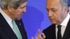 French Foreign Affairs Minister Laurent Fabius (R) speaks with U.S. Secretary of State John Kerry after a news conference at the ministry in Paris, February 27, 2013. 