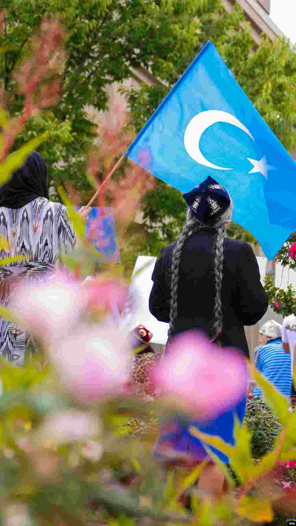 Uyg&#39;urlar Sharqiy Turkiston bayroqlarini ko&#39;tarib, Xitoy elchixonasi qarshisida bu davlatning uyg&#39;urlarga qarshi siyosatini qoralab, namoyish qilmoqda, Vashington, 3-avgust, 2014-yil. Odil Ruzaliev surati