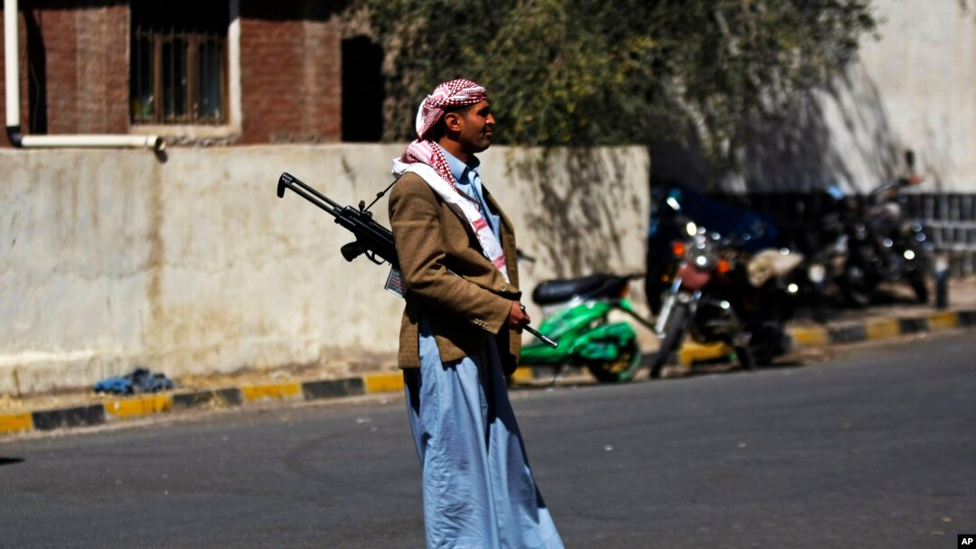 An armed Houthi Shi'ite Yemeni stands guard outside the Republican Palace in Sana'a, Feb. 16, 2015.
