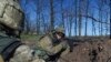 FILE - Ukrainian military servicemen control their position during a cease-fire outside Avdiivka, eastern Ukraine, April 16, 2016. 