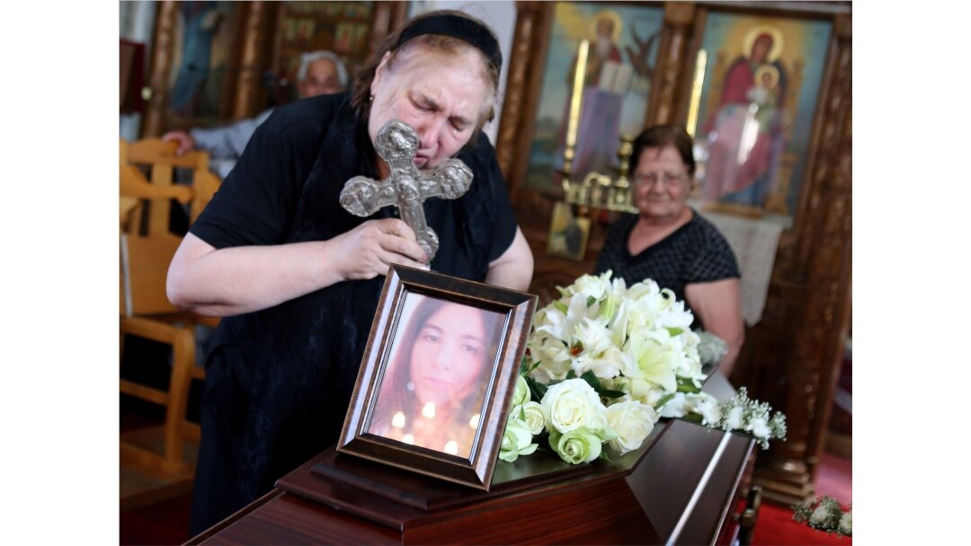 The mother of Livia Florentina Bunea of Romania leans over to kiss a cross during the funeral of Bunea, 36, and her 8-year-old daughter, Elena Natalia, in Arediou, Cyprus, June 13, 2019. The pair are believed to have been victims of a serial killer.