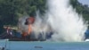 FILE - In this image made from video, an illegal fishing vessel that was seized by Indonesia’s navy is sunk in the waters off Pangandaran, West Java, Indonesia, March 14, 2016. 