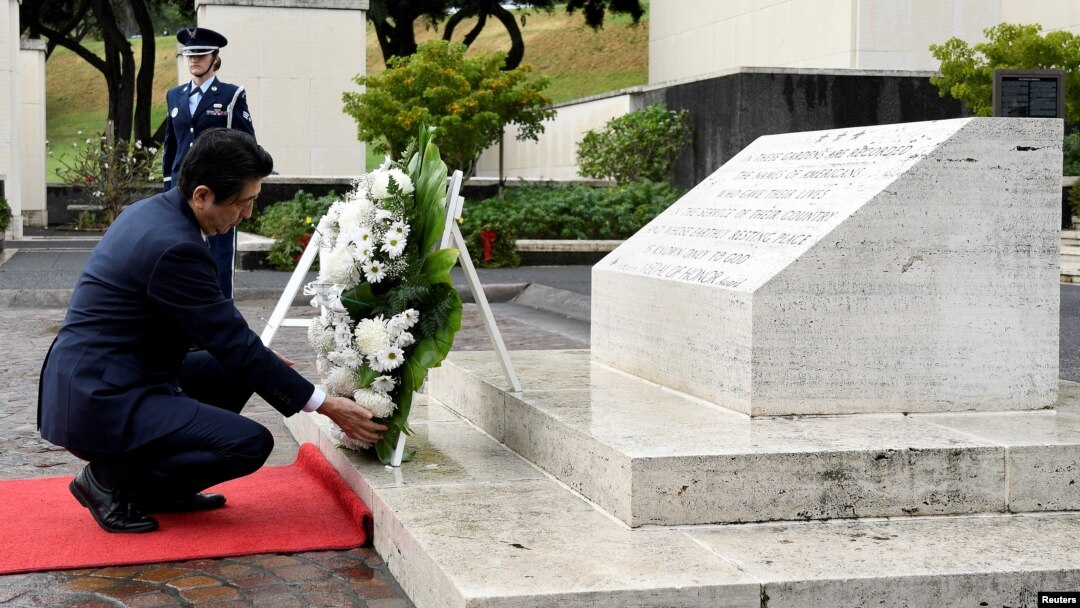 Japan's Prime Minister Shinzo Abe presents a wreath at the National Memorial Cemetery of the Pacific at Punchbowl in Honolulu, Hawaii, Dec. 26, 2016.