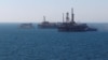 FILE PHOTO: The state flag of Azerbaijan flutters in the wind on an oil platform in the Caspian Sea east of Baku, Azerbaijan, January 22, 2013. REUTERS/David Mdzinarishvili/File Photo - RTS1474L