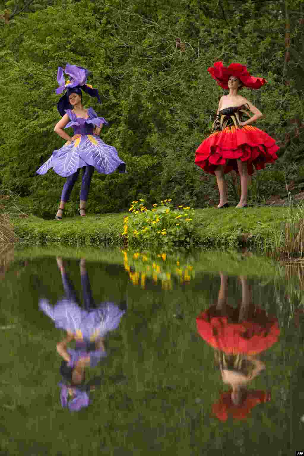 Models Lauren Green (L) and Abi Moore wear floral dress creations, representing an iris and a poppy respectively, by New Zealand artist Jenny Gillies as they pose on the eve of the opening day of the Harrogate Spring Flower Show at the Great Yorkshire Showground in Harrogate, northern England. The flower show features over 1,000 exhibitors and hosts the UK's biggest exhibition by flower arrangers and florists.