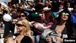 FILE - Women breastfeed babies during a mass event in Athens, Greece, Nov. 2, 2014.