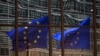 FILE - European Union flags at the EU headquarters in Brussels. 