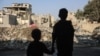 Children look at the destruction following an Israeli strike in the Nuseirat refugee camp in the central Gaza Strip on Nov. 7, 2024.
