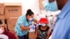 FILE - A nurse administers the Johnson & Johnson COVID-19 vaccine to Rosemene Lordeus, right, at a clinic held by Healthcare Network in Immokalee, Fla., April 10, 2021.
