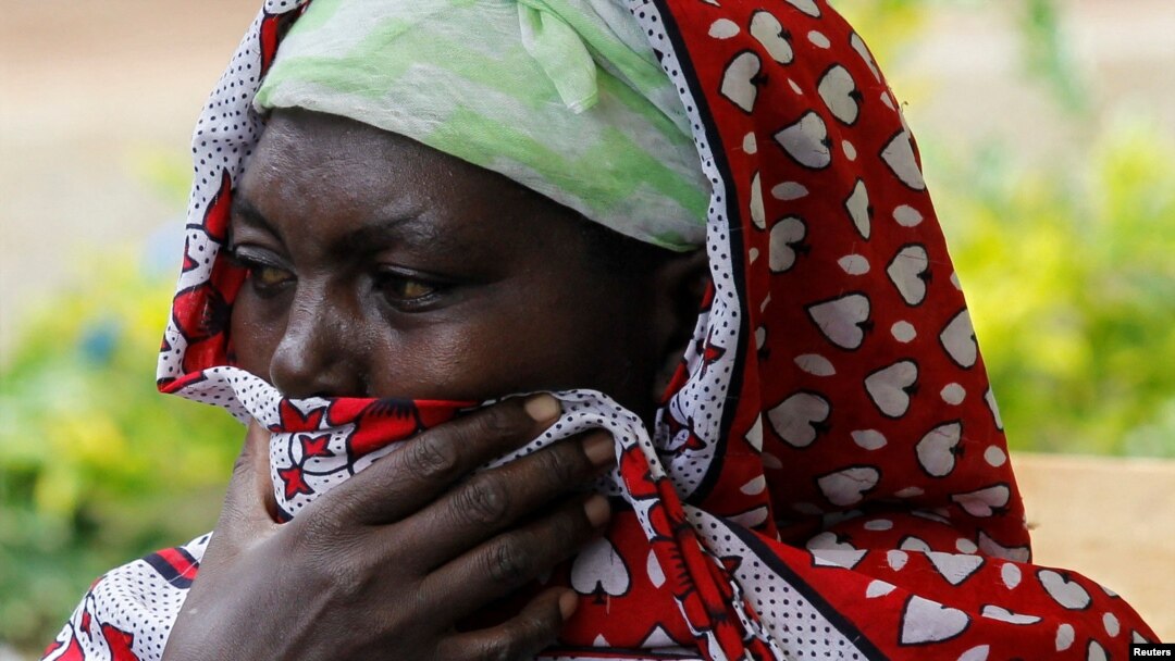 A woman reacts as members of the Kenya Defense Forces search for the bodies of missing people after flash floods wiped out several homes following heavy rains in Kamuchiri village of Mai Mahiu, Kenya, on May 1, 2024.