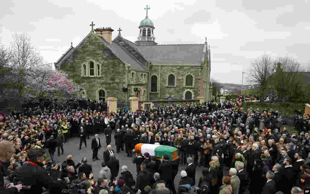The coffin of former IRA commander and Sinn Fein deputy leader Martin McGuinness is carried toward St. Columba's Church in Londonderry, Northern Ireland.