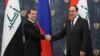 Russian Prime Minister Dmitry Medvedev shakes hands with Iraq's Prime Minister Nouri Al-Maliki, right, prior to their meeting outside Moscow, October 9, 2012.