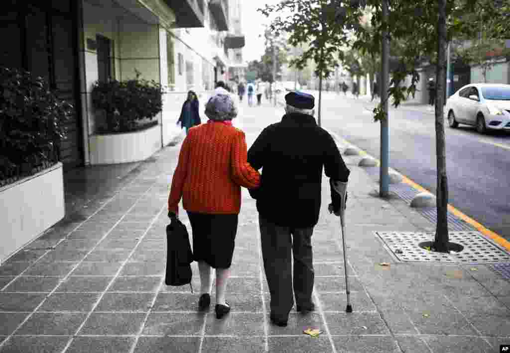 Maria, 84, and Raul, 87, run errands in Santiago, Chile, May 3, 2017. The couple said they've been married for 40 years.