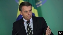 Brazil's President Jair Bolsonaro speaks during a ceremony where he signed a decree loosening restrictions on owning a firearm at Planalto presidential palace in Brasilia, Jan. 15, 2019. 