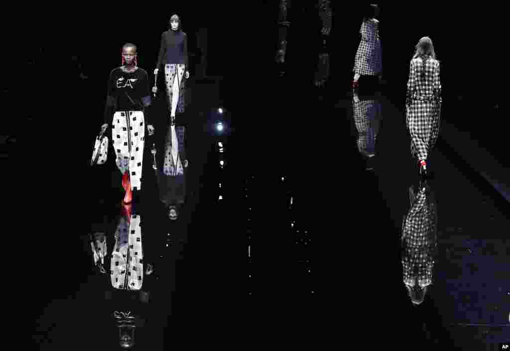 Models wear creations for Emporio Armani women's Fall-Winter 2017-2018 collection, part of Milan Fashion Week, unveiled in Milan, Italy.
