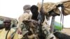 Militiamen from the Ansar Dine Islamic group sit on a vehicle in Gao in northeastern Mali, June 18, 2012. 