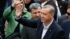 Turkey’s President Recep Tayyip Erdogan waves to supporters after voting at a polling station in Istanbul, June 7, 2015.