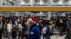 Travelers wait in line for security checks at the Los Angeles International Airport in Los Angeles, Dec. 24, 2024.