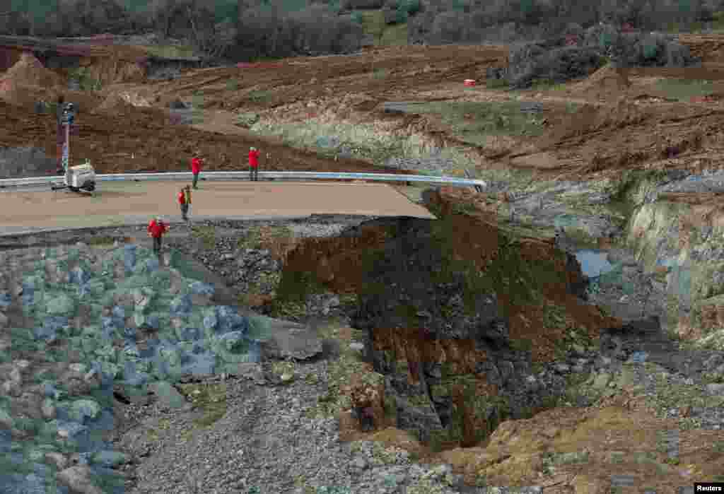 California Department of Water Resources crews inspect and evaluate the erosion just below the Lake Oroville Emergency Spillway site after lake levels receded, in Oroville, California, Feb. 13, 2017.
