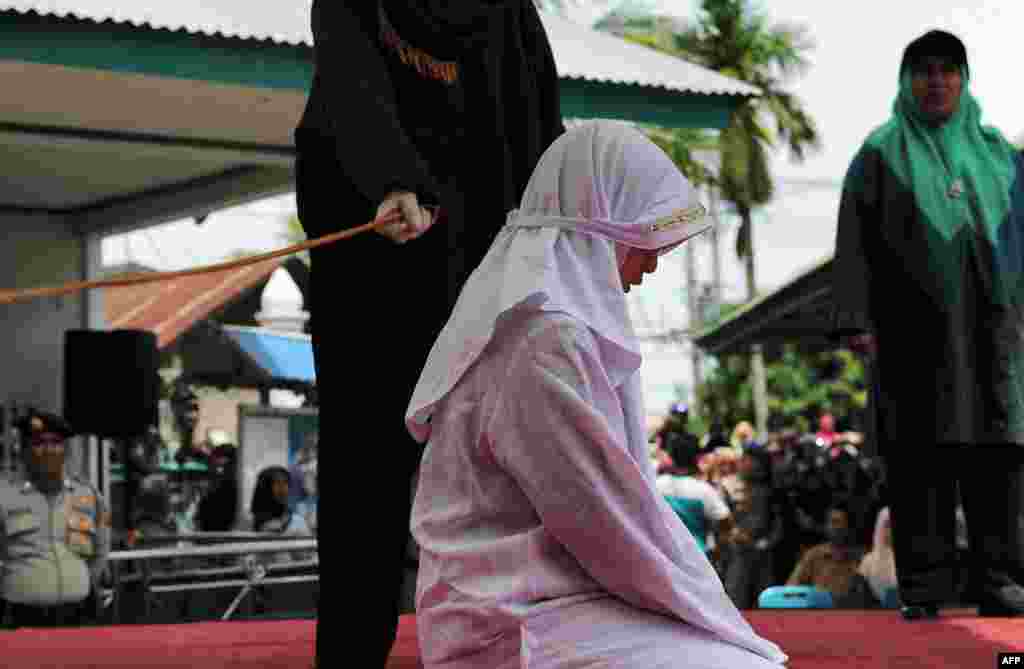 One of four Acehnese teens gets whipped for spending time in close proximity with her boyfriend, which is against Sharia law, in Aceh.