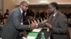 President of ECOWAS) Desire Kadre Ouedraogo (R), greets Malian Foreign Minister Tieman Coulibaly on Sept. 17, 2012 in Abidjan