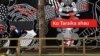 FILE - People walk past Maori language signs in Wellington, New Zealand, Sept. 13, 2018.