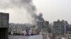 Smoke from burning tires rises over the Tripoli, Lebanon, skyline as people protest the killing Friday in Beirut of the country's intelligence chief, Brig. Gen. Wissam al-Hassan and at least seven others, October 20, 2012. 