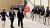 U.S. Vice President Mike Pence, third from left, and Japan's Prime Minister Shinzo Abe review an honor guard before their meeting at Abe's official residence in Tokyo Wednesday, Feb. 7, 2018. 