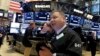 Trader George Ettinger works on the floor of the New York Stock Exchange, Nov. 13, 2015. 