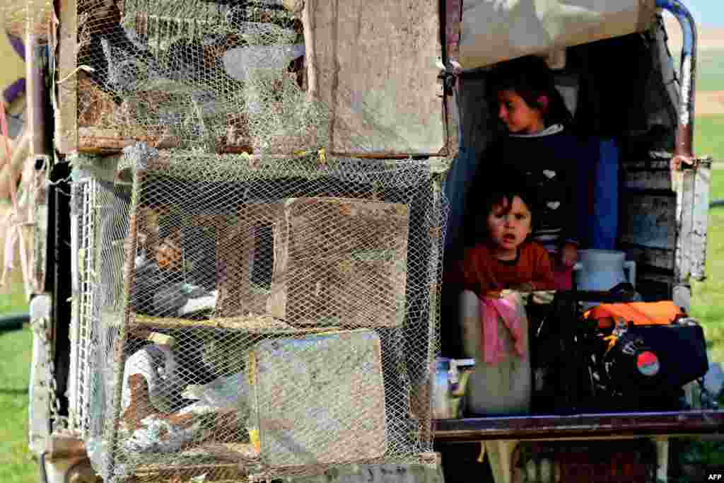 Displaced Syrians gather at a makeshift camp near the northern town of Manbij as the number of people fleeing from the northern province of Aleppo rises due to intensified battles between Syrian government forces and Islamic State fighters.