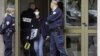 French police officers stand guard at the entrance of a building in Strasbourg, France, Saturday Oct. 6, 2012, where a suspect was shot dead after firing at police.