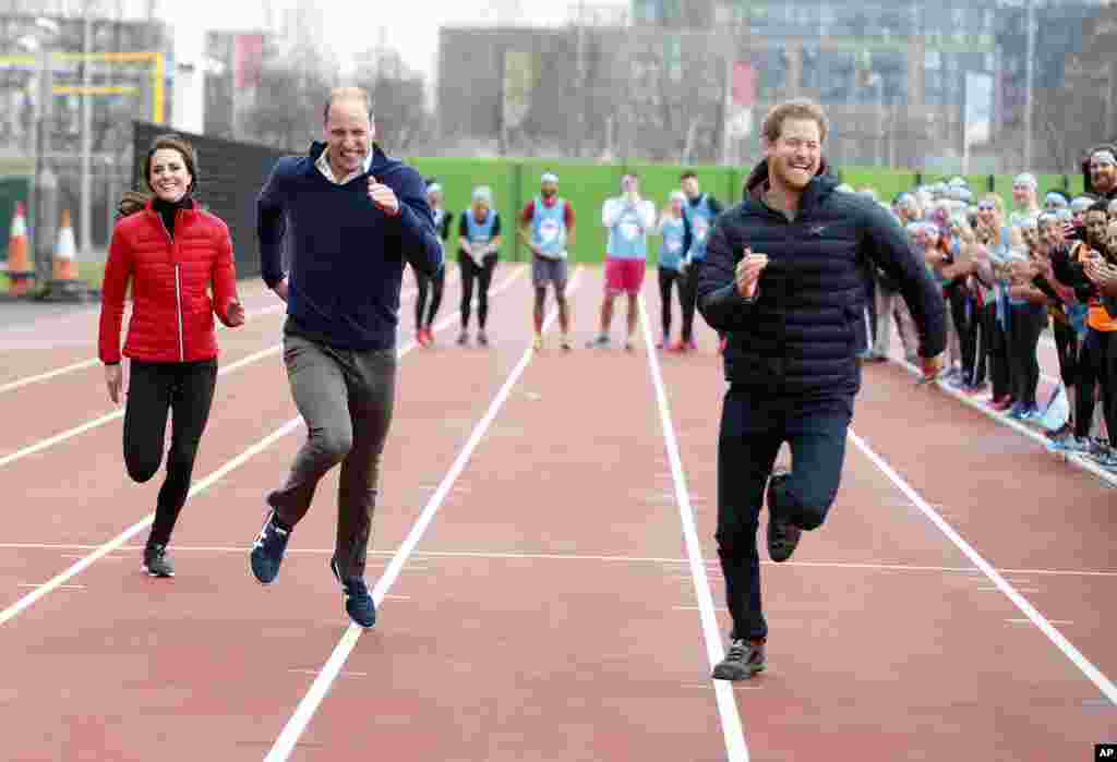 Britain&#39;s Prince William, second left, Kate, the Duchess of Cambridge, left, and Prince Harry take part in a relay race, during a training event to promote the charity Heads Together, at the Queen Elizabeth II Park in London.