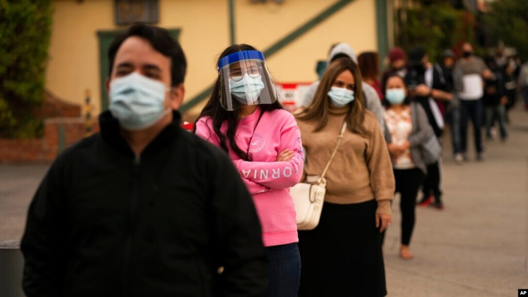 FILE - People wait in line for COVID-19 testing in Los Angeles, Dec. 7, 2020.