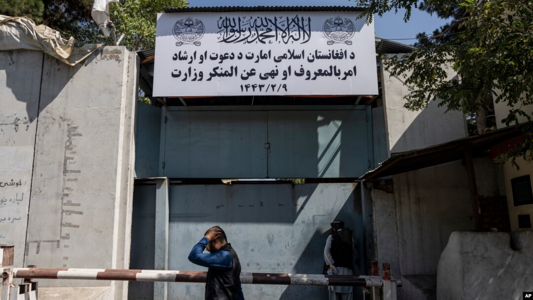 A man walks past the now closed Women's Affairs Ministry building in Kabul, Afghanistan, Sept. 18, 2021.