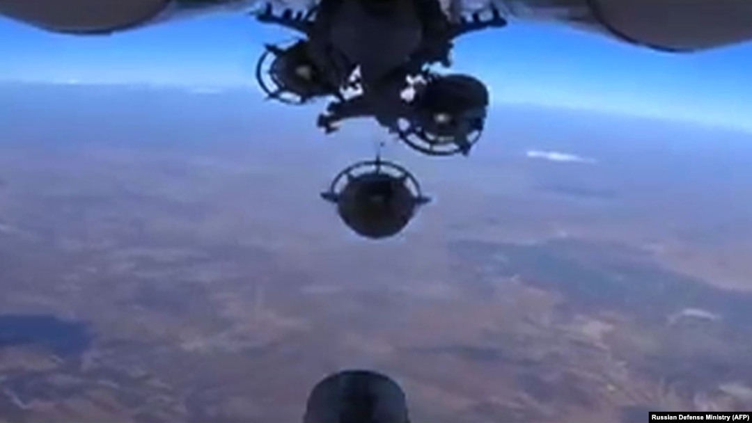 An image grab made from a video released Oct. 5, 2015, by the Russian Defense Ministry reportedly shows a Russian aircraft dropping bombs during an airstrike against Islamic State group's positions at an undisclosed location in Syria. 