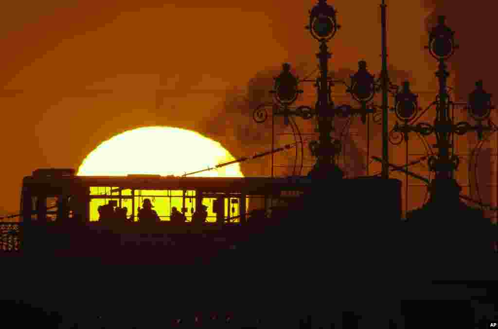 People ride a bus at sunset in St.Petersburg, Russia.