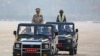 FILE - Myanmar's junta leader General Min Aung Hlaing, who ousted the country's elected government in a Feb. 1 coup, presides an army parade on Armed Forces Day in Naypyitaw, Myanmar, March 27, 2021.